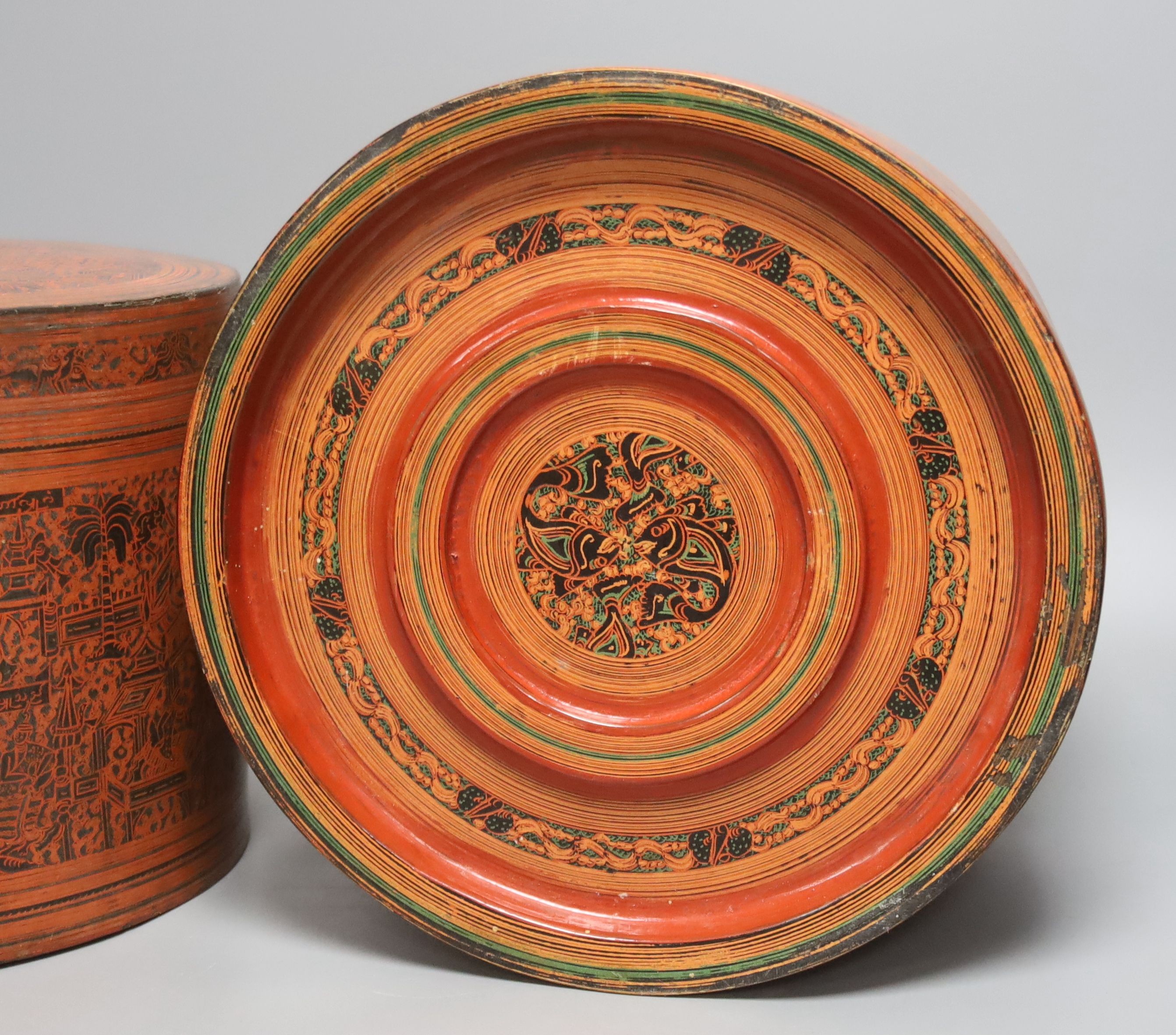 A large Burmese red and black lacquer betel box and cover with internal tray, late 19th century, 22cm